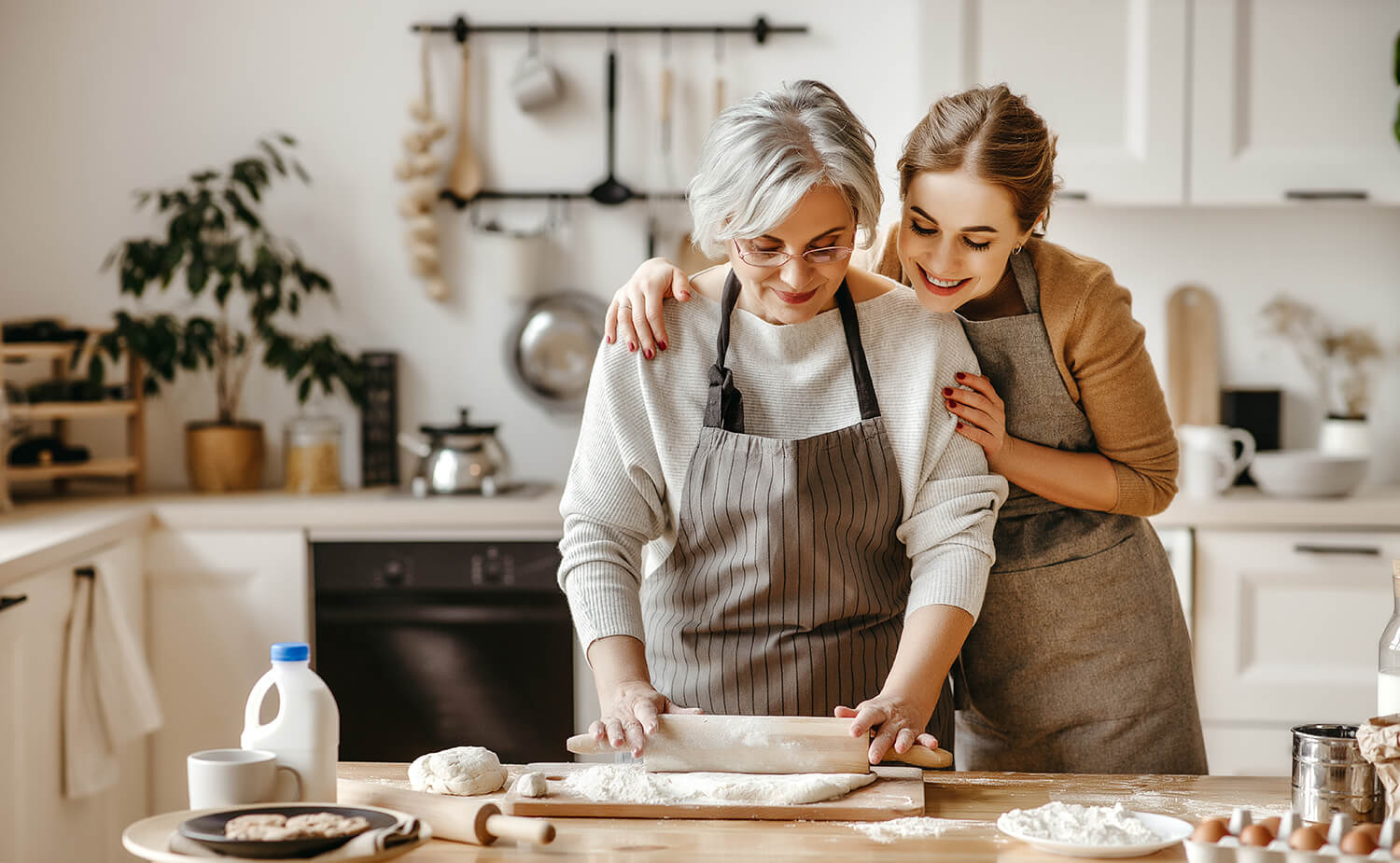 grandma showing granddaughter how to bake